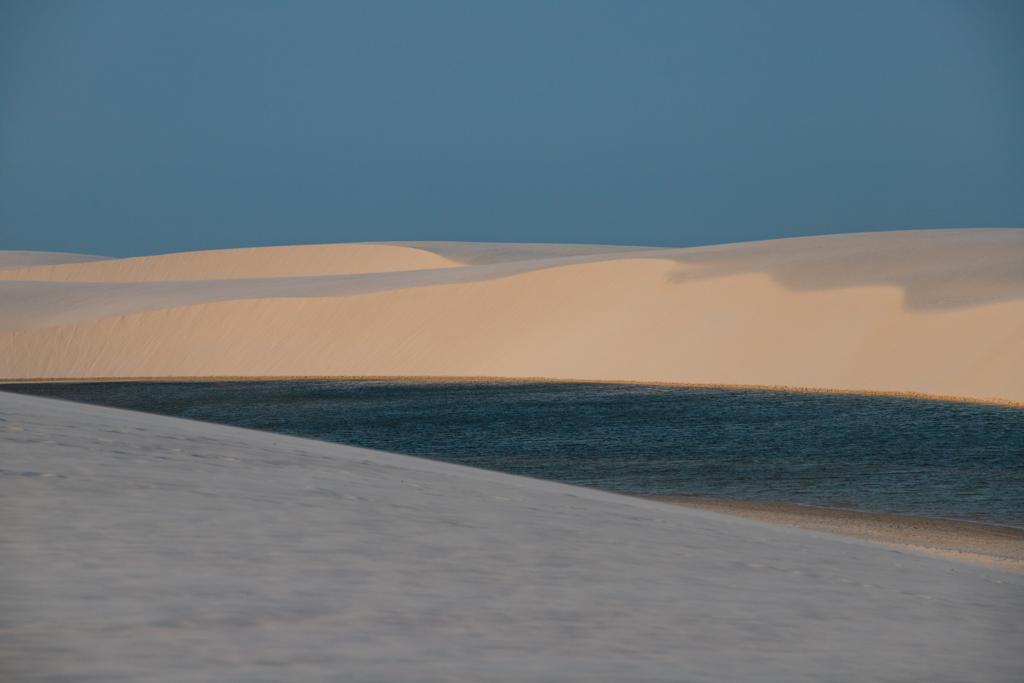 Lagoa cristalina entre dunas brancas no Parque Nacional dos Lençóis Maranhenses